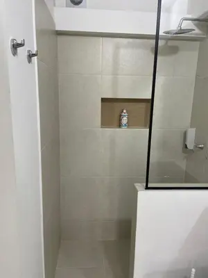 a bathroom with a shower with a glass door at Poblado Park Aparta Estudio in El Poblado