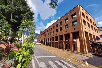 a large brick building on a city street at Poblado Park Aparta Estudio in El Poblado
