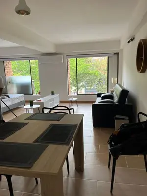 a living room with a table and a couch at Poblado Park Aparta Estudio in El Poblado