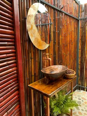 a sink on a wooden table next to a fence at La Paloma Glamping in Palestina