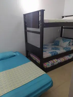 a room with two bunk beds and a bed at Apartamento vista piscina principal in Santa Fe de Antioquia