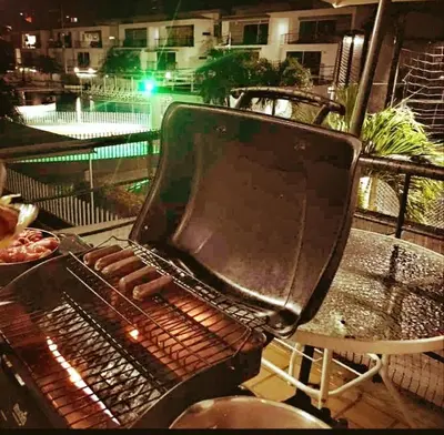 a grill with a bunch of hot dogs on it at Apartamento vista piscina principal in Santa Fe de Antioquia