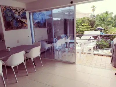 a dining room with a table and chairs and a patio at Apartamento vista piscina principal in Santa Fe de Antioquia
