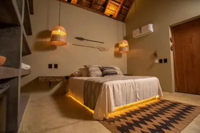 a bedroom with a bed with lights on it at Nativa Refugio Escondido in Santa Fe de Antioquia