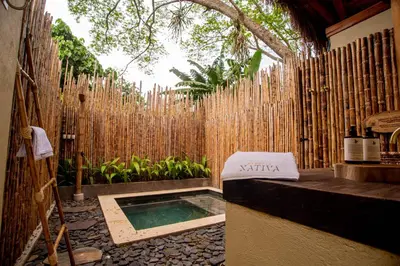 a backyard with a swimming pool and a wooden fence at Nativa Refugio Escondido in Santa Fe de Antioquia