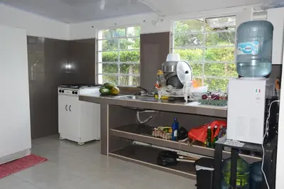 a kitchen with a sink and a counter top at VILLA ALEJANDRIA - CABAÑA LAMARIQUITA-CABAÑA ORQUIDEA-CABAÑA CARAMBOLa in Mariquita