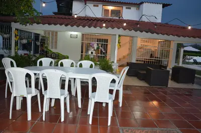 a white table and chairs on a patio at VILLA ALEJANDRIA - CABAÑA LAMARIQUITA-CABAÑA ORQUIDEA-CABAÑA CARAMBOLa in Mariquita
