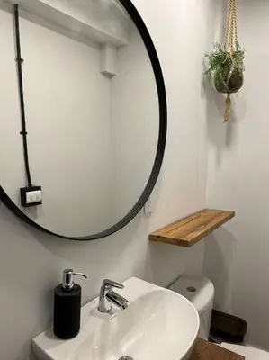 a bathroom with a sink and a mirror over a toilet at Hospedaje en Medellí cerca a Laureles NID103 By Roots Rentals in Medellín