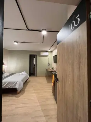 a room with a bed and a door with a sign at Hospedaje en Medellí cerca a Laureles NID103 By Roots Rentals in Medellín