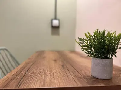a wooden table with a potted plant on it at Hospedaje en Medellí cerca a Laureles NID103 By Roots Rentals in Medellín