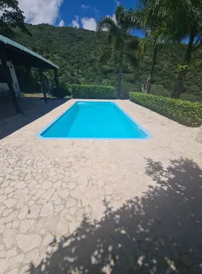 a small blue swimming pool on a stone patio at ENTREPALMAS in San Jerónimo