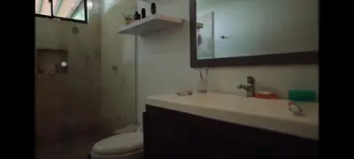a bathroom with a sink and a toilet and a mirror at ENTREPALMAS in San Jerónimo