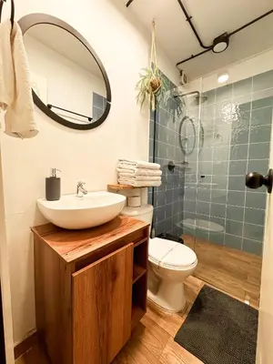 a bathroom with a sink and a toilet and a shower at Alojamiento económico en Medellín - NID104 By Roots Rentals in Medellín