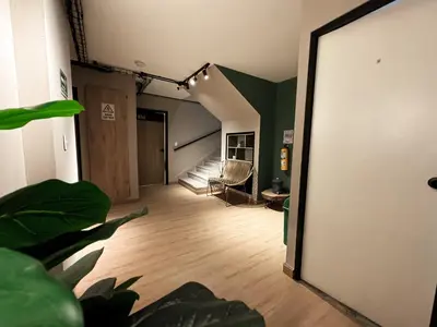 a room with a hallway with a chair and a mirror at Alojamiento económico en Medellín - NID104 By Roots Rentals in Medellín