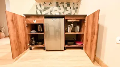 a kitchen with a refrigerator in a cabinet at Alojamiento económico en Medellín - NID104 By Roots Rentals in Medellín