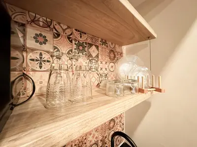 a shelf filled with glass vases on a wall at Apartamento amoblado asiste a Guns N Roses NID201 By Roots Rentals in Medellín