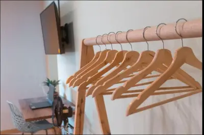 a wooden rack in a room with a desk at Apartamento amoblado asiste a Guns N Roses NID201 By Roots Rentals in Medellín