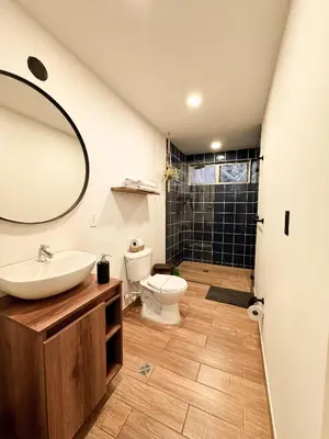 a bathroom with a sink and a toilet and a mirror at Apartamento amoblado asiste a Guns N Roses NID201 By Roots Rentals in Medellín