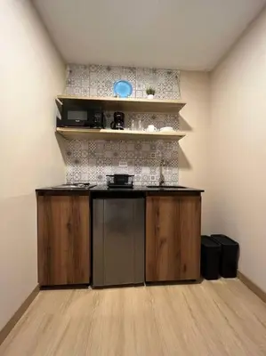 a kitchen with wooden cabinets and a counter top at Amoblado cerca Centro eventos la Macarena NID203 By Roots Rentals in Medellín