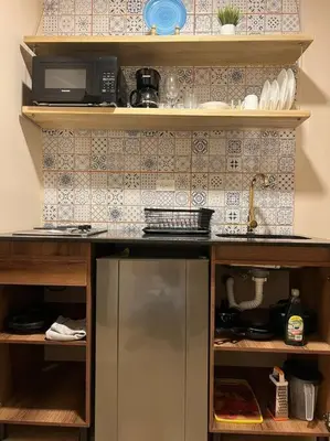 a kitchen with a refrigerator and a microwave at Amoblado cerca Centro eventos la Macarena NID203 By Roots Rentals in Medellín
