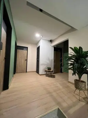 a hallway with a potted plant in a building at Amoblado cerca Centro eventos la Macarena NID203 By Roots Rentals in Medellín