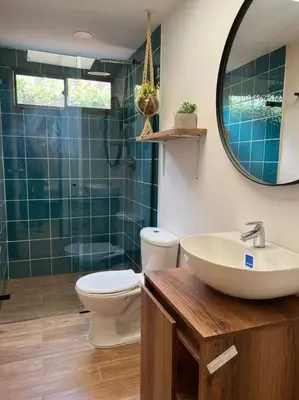 a bathroom with a sink and a toilet and a mirror at Amoblado cerca Centro eventos la Macarena NID203 By Roots Rentals in Medellín