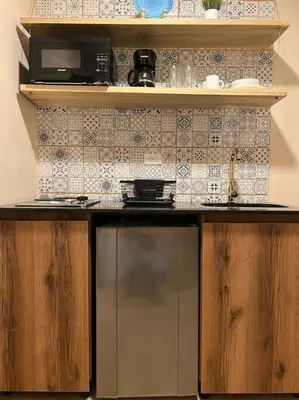 a kitchen with a microwave and a counter top at Amoblado cerca Centro eventos la Macarena NID203 By Roots Rentals in Medellín