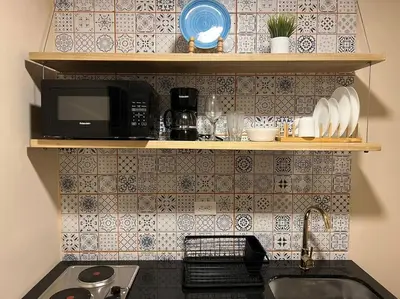 a kitchen with a sink and a microwave at Amoblado cerca Centro eventos la Macarena NID203 By Roots Rentals in Medellín