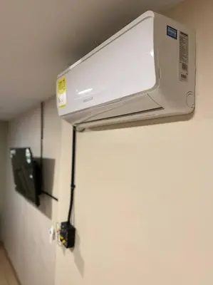 a microwave hanging on a wall in a room at Amoblado cerca Centro eventos la Macarena NID203 By Roots Rentals in Medellín
