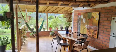 a patio with a table and chairs and a brick wall at Finca El Peñol in Guatapé