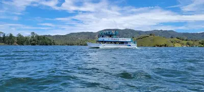 a boat in the middle of a large body of water at Finca El Peñol in Guatapé