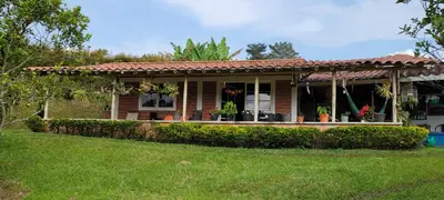 a house with a porch with plants on it at Finca El Peñol in Guatapé