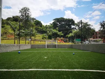a soccer field with blue balls on the grass at Lugar encantador en Santa Fe de Antioquia in Santa Fe de Antioquia
