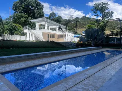 a house with a swimming pool in front of a house at Lugar encantador en Santa Fe de Antioquia in Santa Fe de Antioquia