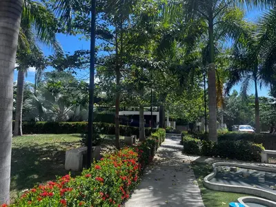 a garden with flowers and palm trees in a park at Lugar encantador en Santa Fe de Antioquia in Santa Fe de Antioquia