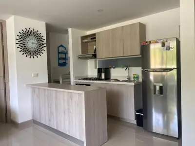a kitchen with a stainless steel refrigerator and cabinets at Lugar encantador en Santa Fe de Antioquia in Santa Fe de Antioquia