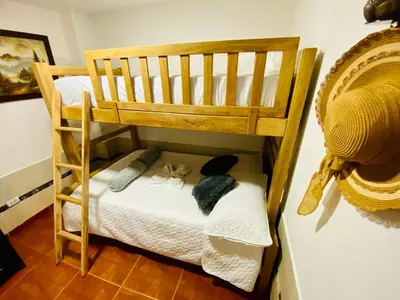 a wooden bunk bed with stuffed animals in a room at Noches de Guatapulco in Guatapé