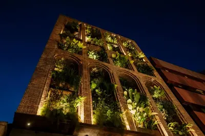 a tall building with plants on the side of it at Hotel El Zarzo in Medellín