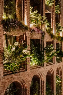 a brick building with plants on the side of it at Hotel El Zarzo in Medellín
