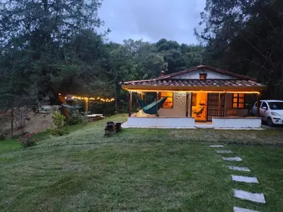 a small house with a yard in front of it at Casa Rustica con chimenea en su interior, rodeado de los cuatro elementos tierra, fuego, aire y agua, ubicada en sector tranquilo, para descansar en familia o amigos, in Mazo
