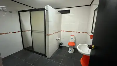 a bathroom with a shower and a toilet and a sink at Finca Hotel Rios Claros in San Luis