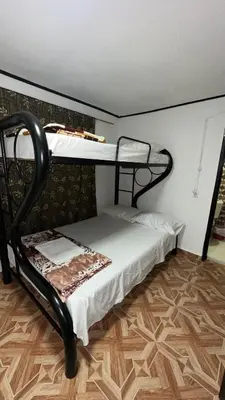a bedroom with two bunk beds and a wooden floor at Finca Hotel Rios Claros in San Luis