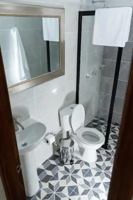 a bathroom with a toilet and a sink at La Casa de Ana 2 in Jardin