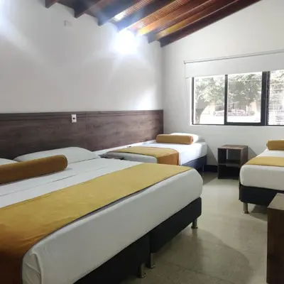 a room with two beds and a window at Hotel Boutique Estadio in Medellín