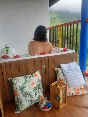 a man in a bath tub on a balcony at Jaibaná Spa in Támesis