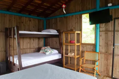 a room with two bunk beds and a television at Jaibaná Spa in Támesis