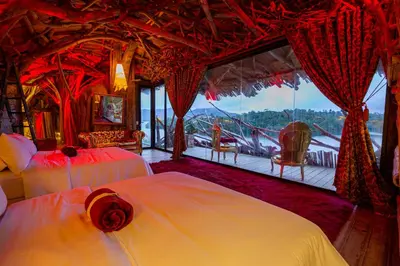 a bedroom with two beds and a large window at Bethel Lozana Guatape in Guatapé