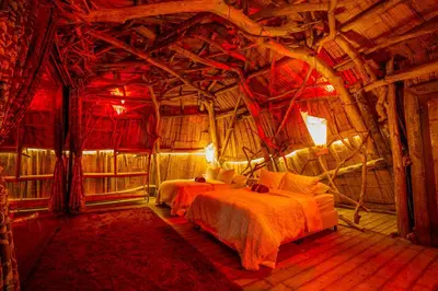 a bedroom with two beds in a room with wooden ceilings at Bethel Lozana Guatape in Guatapé