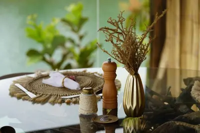 a table with a vase and other items on it at Bethel Lozana Guatape in Guatapé