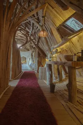 a long hallway with wooden ceilings and a red carpet at Bethel Lozana Guatape in Guatapé
